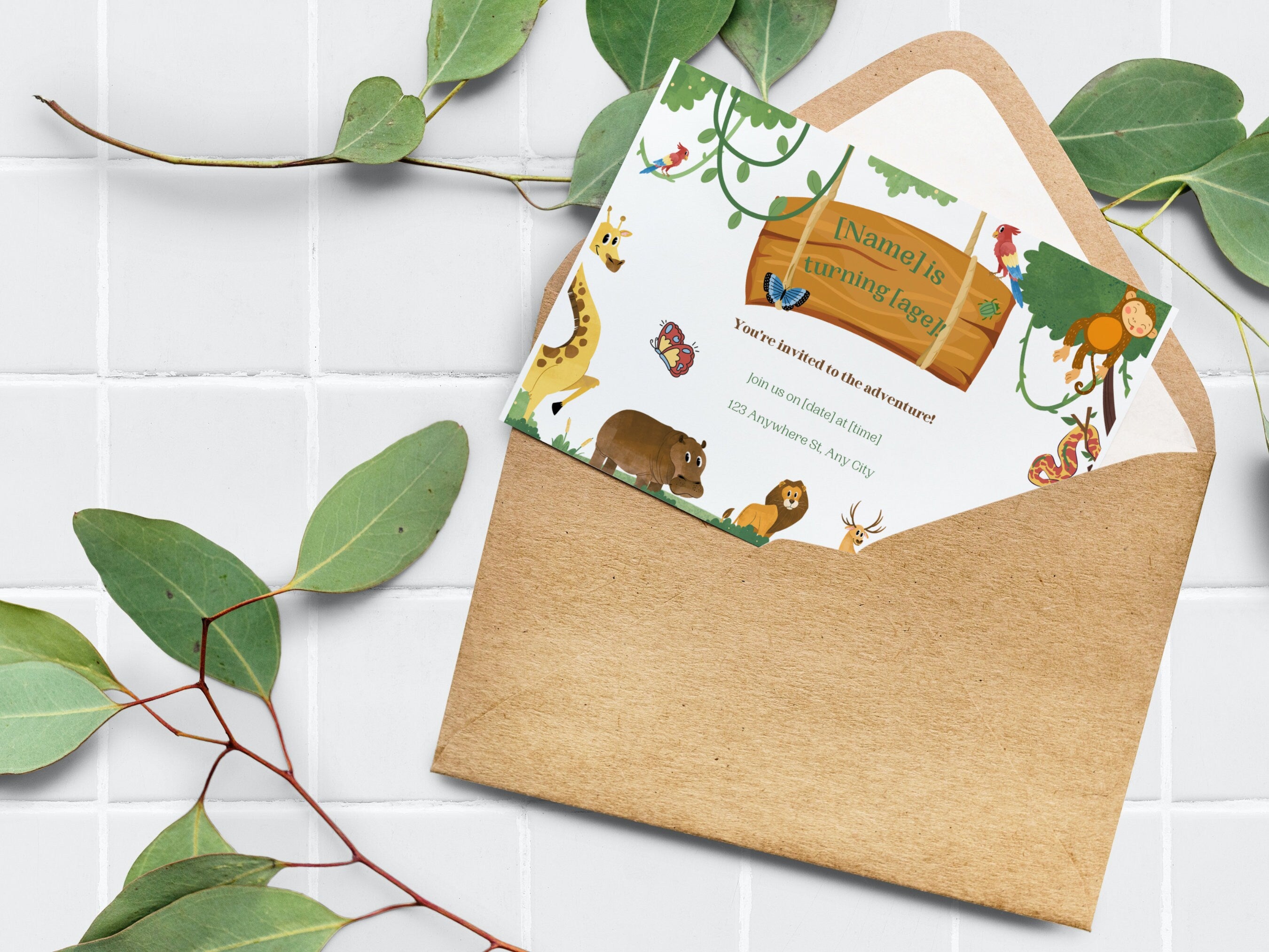 Jungle-themed invitation card in a brown envelope with green leaves on a white background